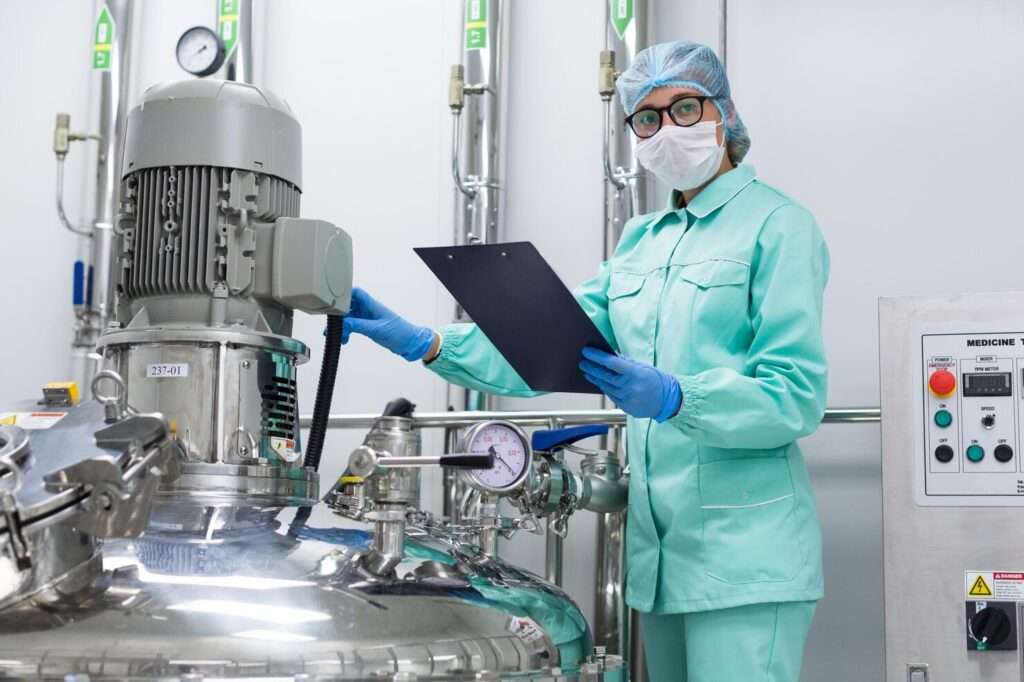 JD Pharma engineer inspecting and documenting pharmaceutical equipment installation to ensure smooth operations in pharma plant.